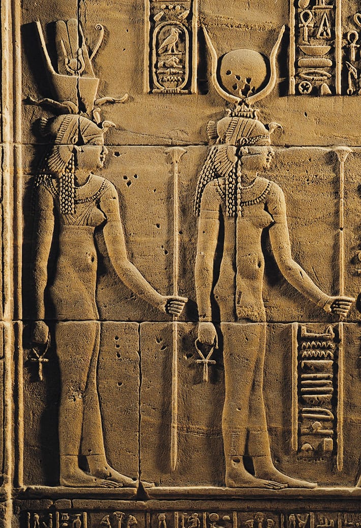 Relief of the goddess Isis and the god Horus carved at the Temple of Philae, symbolizing divine feminine power and sacred kingship