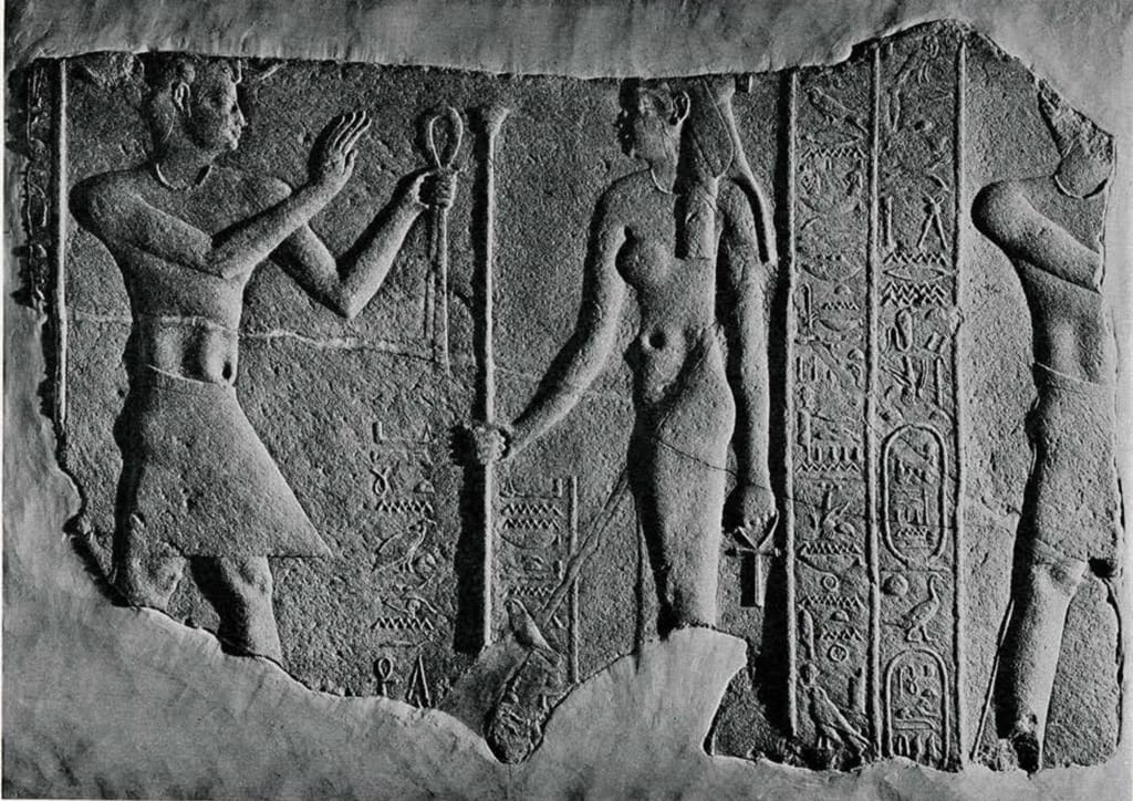 Stone relief of the goddess Isis with Ptolemaic ruler at the Temple of Philae, Egypt