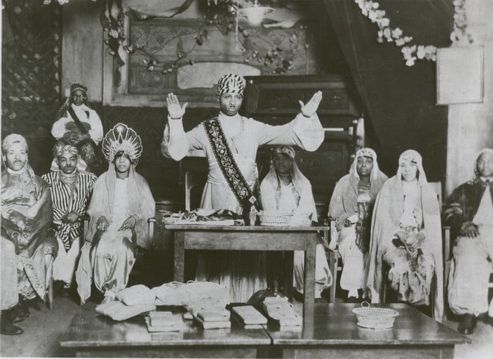 Noble Drew Ali presiding over a Moorish Science Temple gathering in Harlem, 1920s.