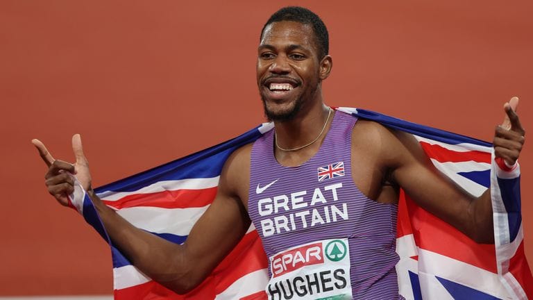 Zharnel Hughes celebrating sprint victory representing manifestation and belief