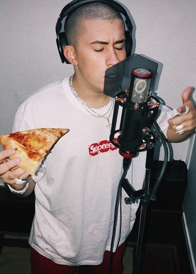 Bad Bunny recording music in a small home studio during his early SoundCloud years.