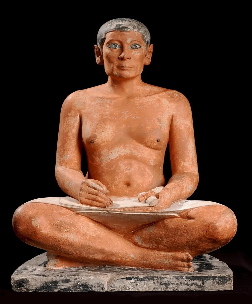 The Seated Scribe from Saqqara (c. 2600–2350 BC), depicting a figure fixed in attentive stillness, embodying identity as a stable inner position that endures independently of time.