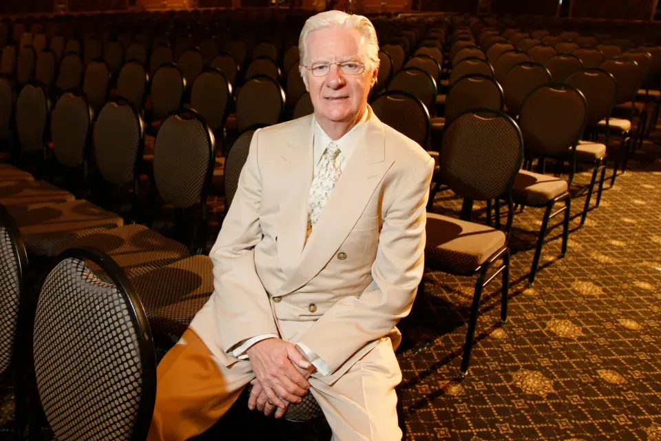Bob Proctor sitting in a seminar hall before teaching the Law of Gestation and the Seven Universal Laws