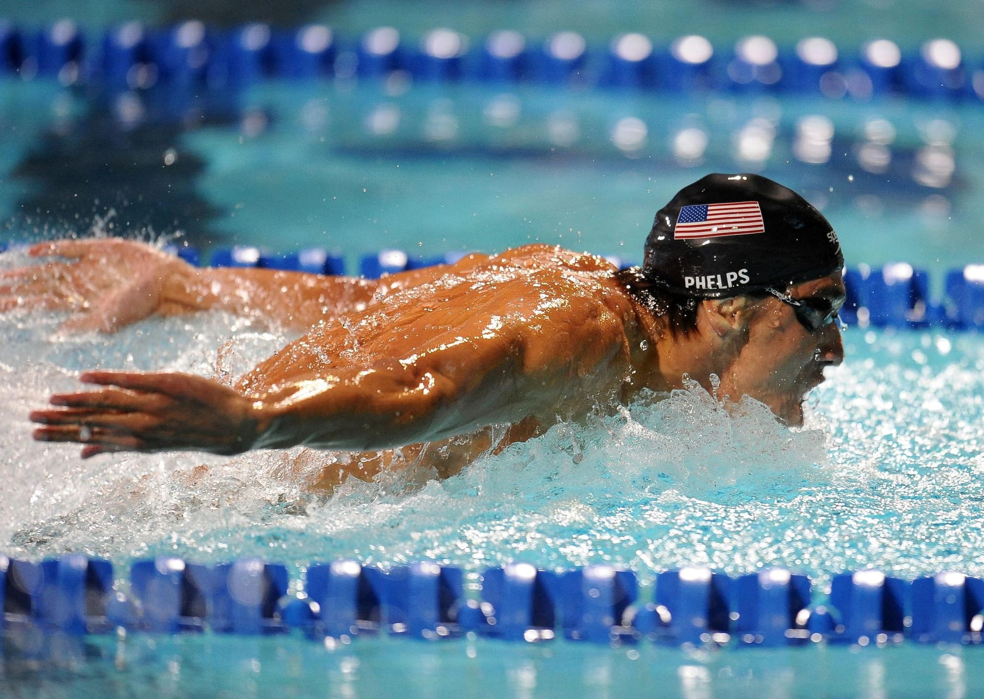 Michael Phelps swimming butterfly stroke during Olympic competition demonstrating elite athletic performance and mental rehearsal training