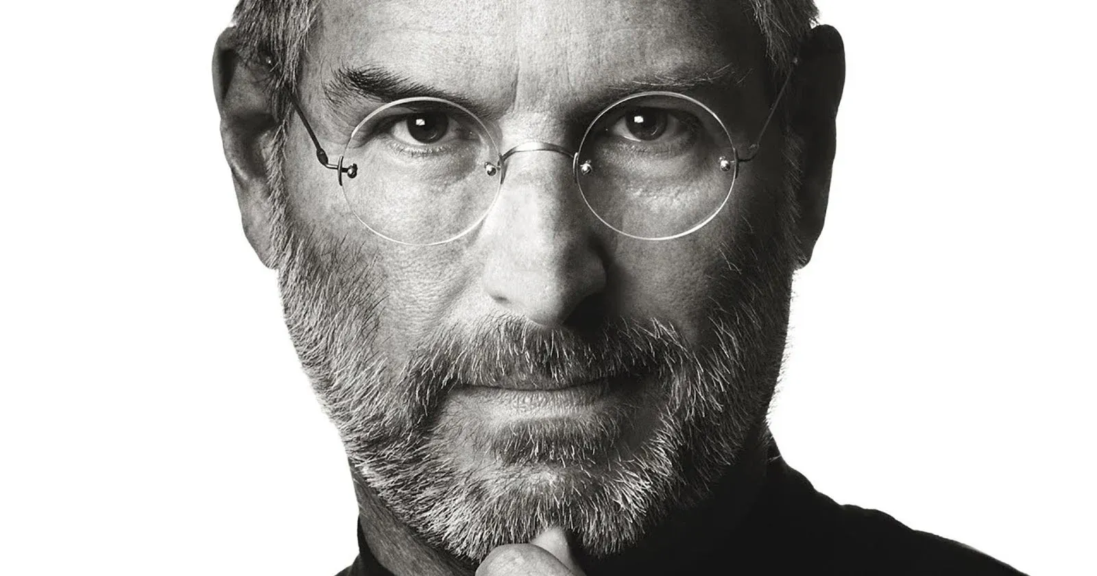 Iconic black and white portrait of Steve Jobs symbolizing visionary thinking