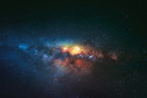 Golden celestial body radiating in space, surrounded by soft baby blue and red hues — symbolizing the cosmic flow of cause and effect.