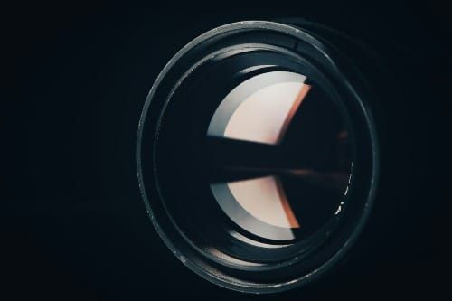 Image of a crystal lens refracting light into different perspectives to manifest the desired reality. 