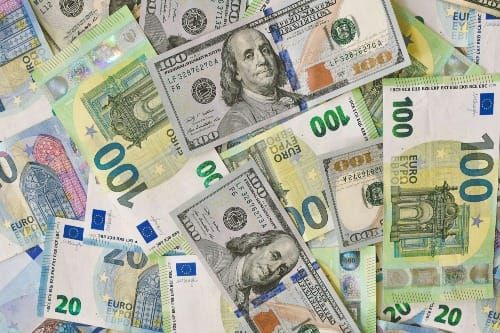 A stack of currency glowing in golden light, symbolizing the energetic nature of money and its manifestation potential