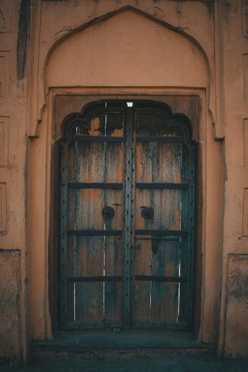 Traditional Islamic arch door shut symbolizing Abdullah shutting the door on Neville Goddard