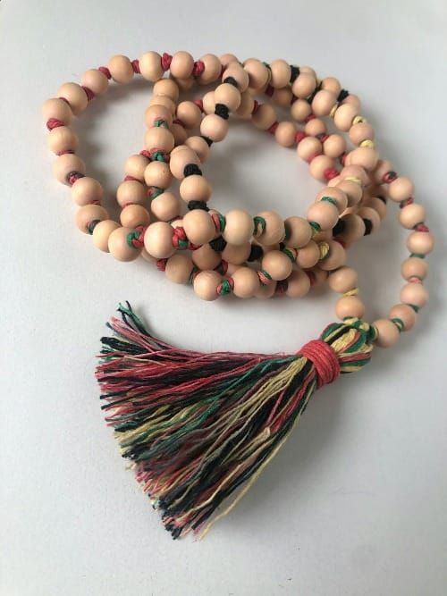 Japa mala beads resting on a sacred cloth, symbolizing mantra meditation, subconscious healing, and the power of manifestation.