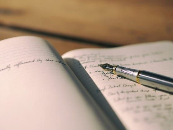 Person writing affirmations in a journal for the 369 manifestation method.