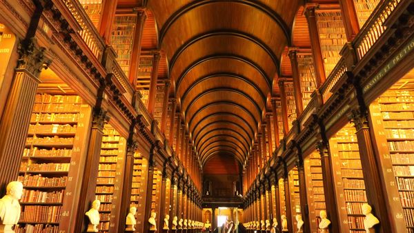 Interior of the Long Room Library at Trinity College Dublin symbolizing the structure, repetition, and knowledge behind subconscious mind reprogramming at The Universe Unveiled Library.