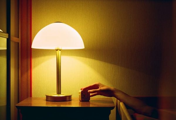 Person lying peacefully before sleep applying Neville Goddard's 3-day subconscious method through SATS and imaginal acts
