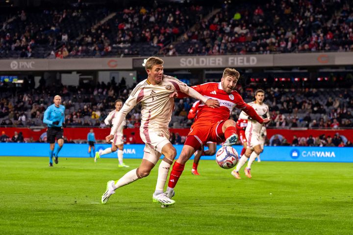 D.C. United's Jackson Hopkins and Johnny Dean of the Chicago Fire battle for a loose ball at Soldier Field on March 14, 2026.