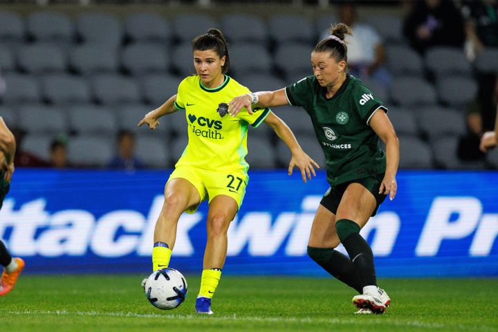 Sofia Cantore controls the ball under pressure from Courtney Petersen during the Washington Spirit's game at Racing Louisville.