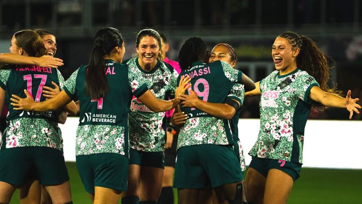 Several Washington Spirit players celebrate a goal during a win over the Kansas City Current.