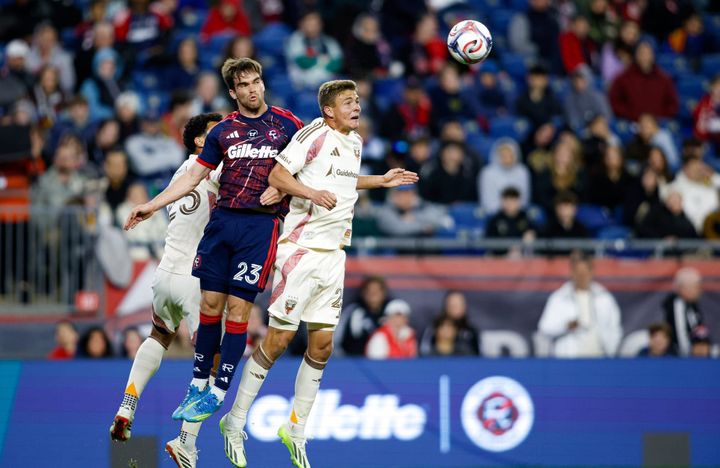 Jackson Hopkins, Will Sands, and Brandon Servania all go up for a header during D.C. United's loss to the New England Revolution.