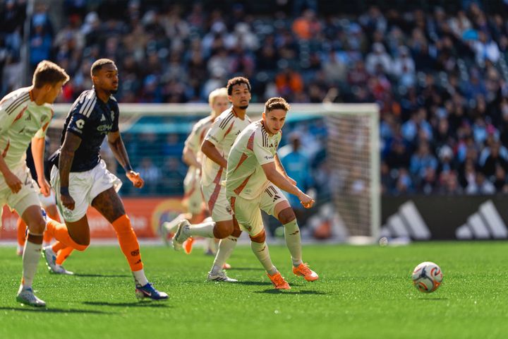 Louis Munteanu strikes a shot as Raul Gustavo and several D.C. United players look on during a game at NYCFC.