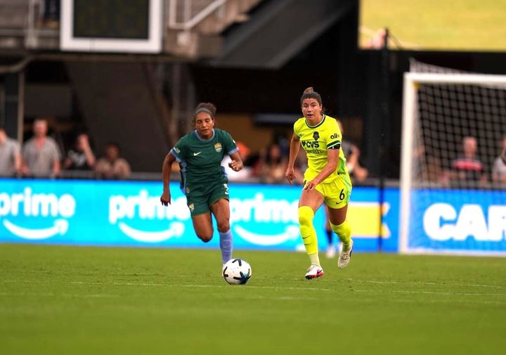 Kate Wiesner drives upfield with the ball with Yazmeen Ryan in pursuit during the Washington Spirit's win over the Denver Summit.