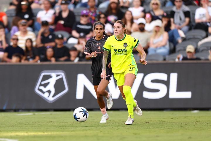 Hal Hershfelt dribbles away from Taylor Suarez during the Washington Spirit's game at Angel City FC.