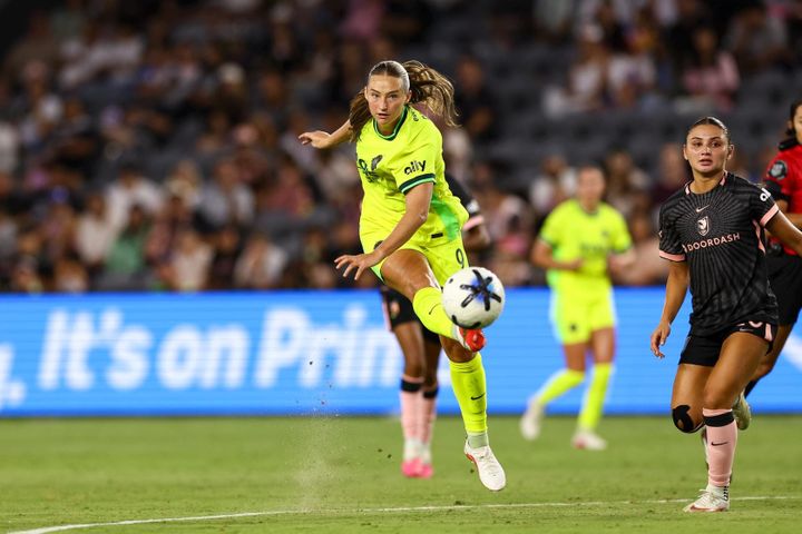 Tara Rudd strikes the ball as Gisele Thompson looks on during the Washington Spirit's game at Angel City FC.