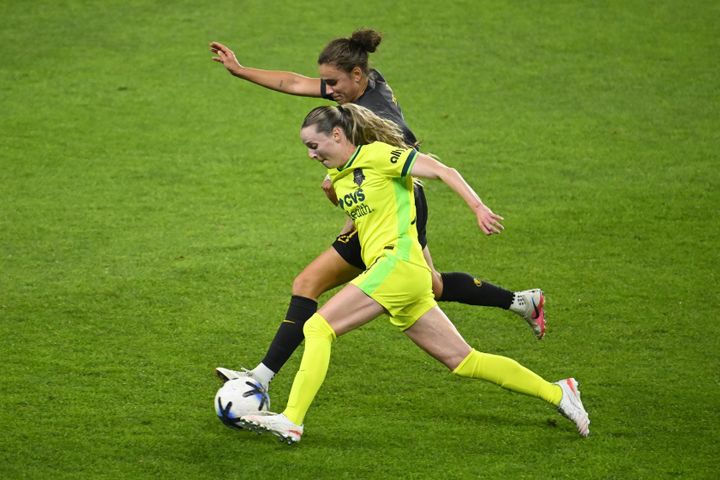 Gabby Carle and Ana Tejada battle for the ball during the Washington Spirit's game against the Utah Royals.