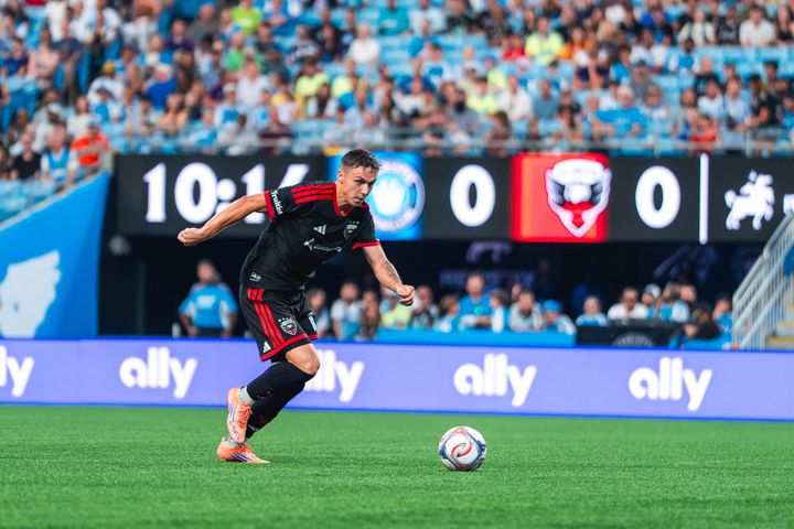 Louis Munteanu prepares to strike the ball during D.C. United's game at Charlotte FC.