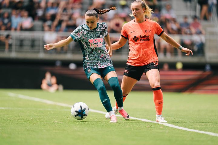 Mélissa Bethi controls the ball as Claire Hutton defends during a game between the Washington Spirit and Bay FC.