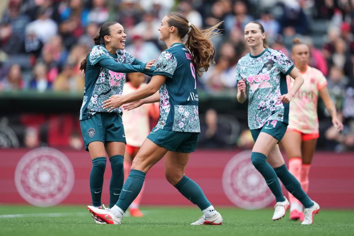 Mélissa Bethi, Tara Rudd, and Gabby Carle celebrate a goal during a game between the Washington Spirit and Portland Thorns.