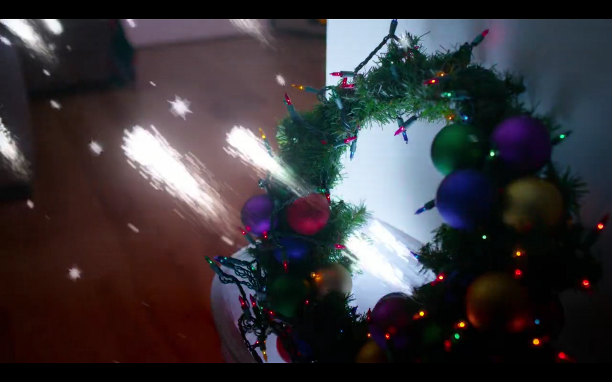 CGI sparks flying from a Christmas wreath.
