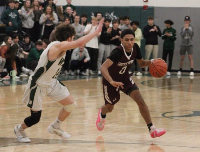 Goffstown boys basketball hangs on for key road win against Dover
