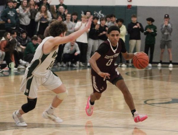 Goffstown boys basketball hangs on for key road win against Dover