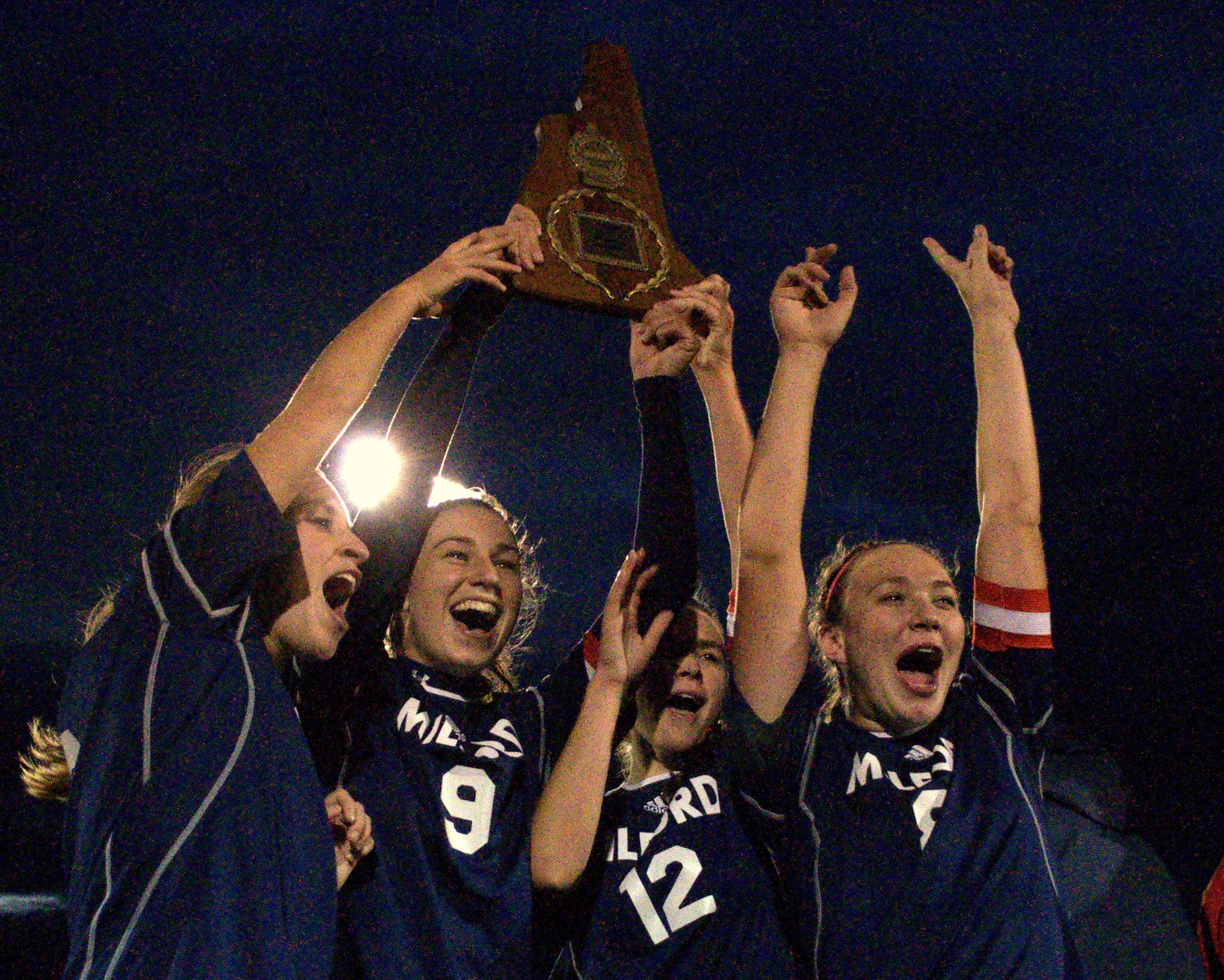 Milford's Morgan Andrews, second from left, celebrates last year's Division II championship with her teammates. Andrews was named Gatorade's National Girls Soccer Player of the Year.