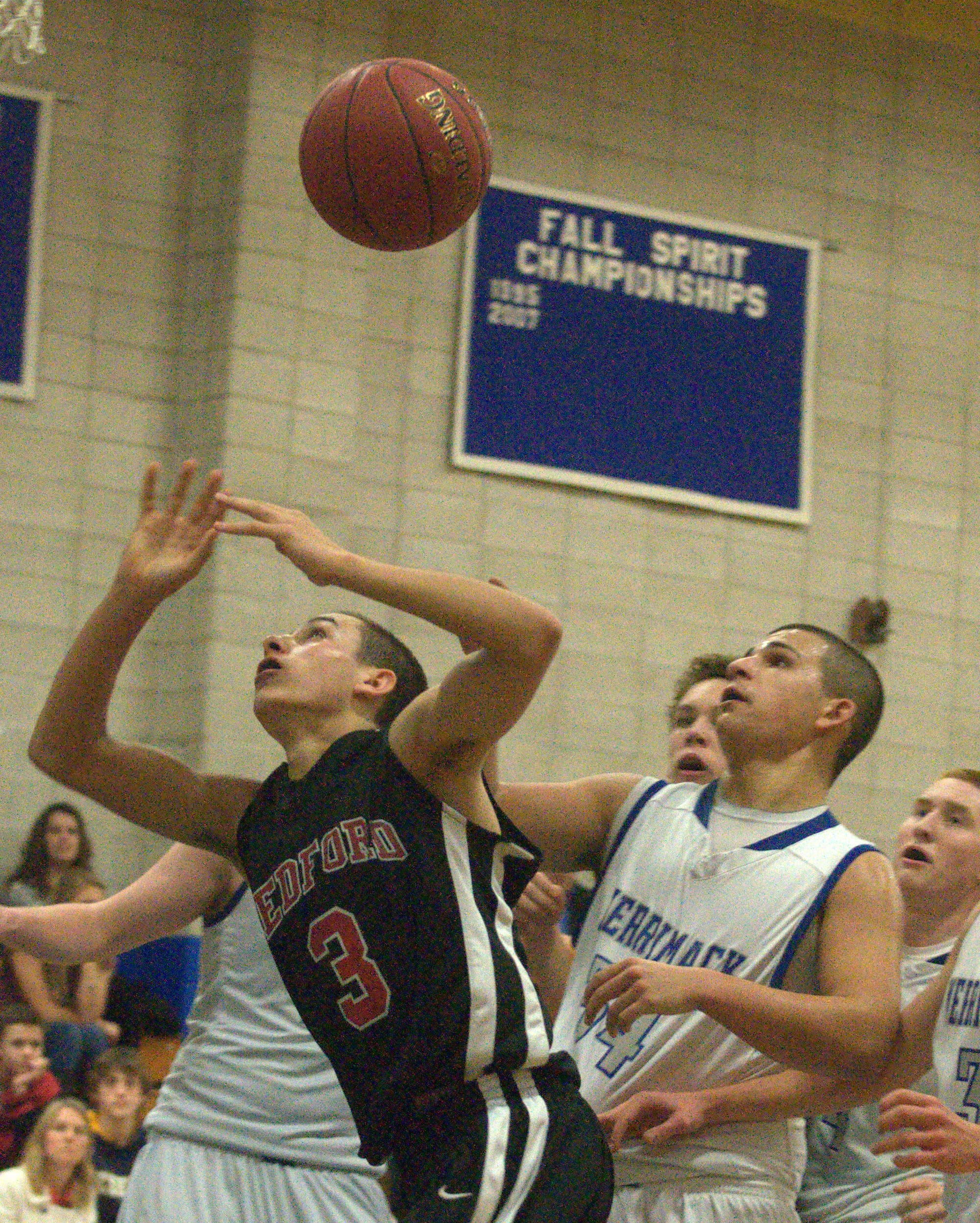 Bedford's Taylor Grande and Merrimack's Mickey Gasper look at the ball after Grande was fouled by Gasper.