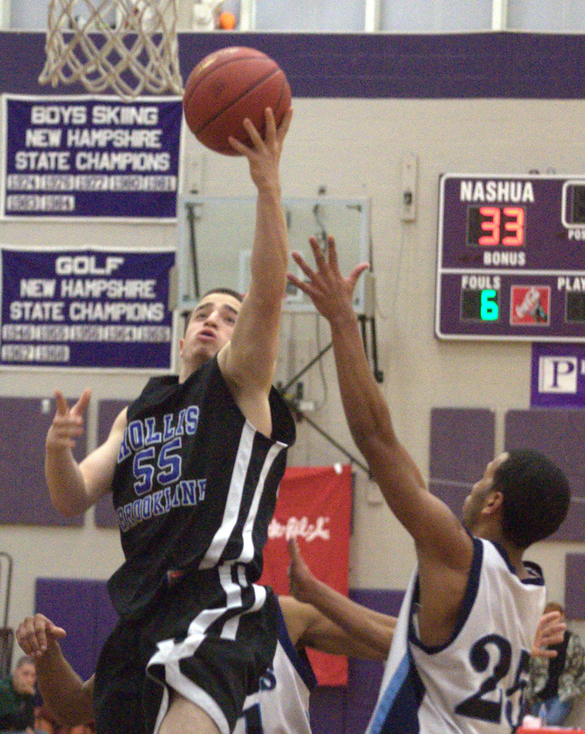 Hollis Brookline's PJ Flaum goes in for a layup during Friday's' game.