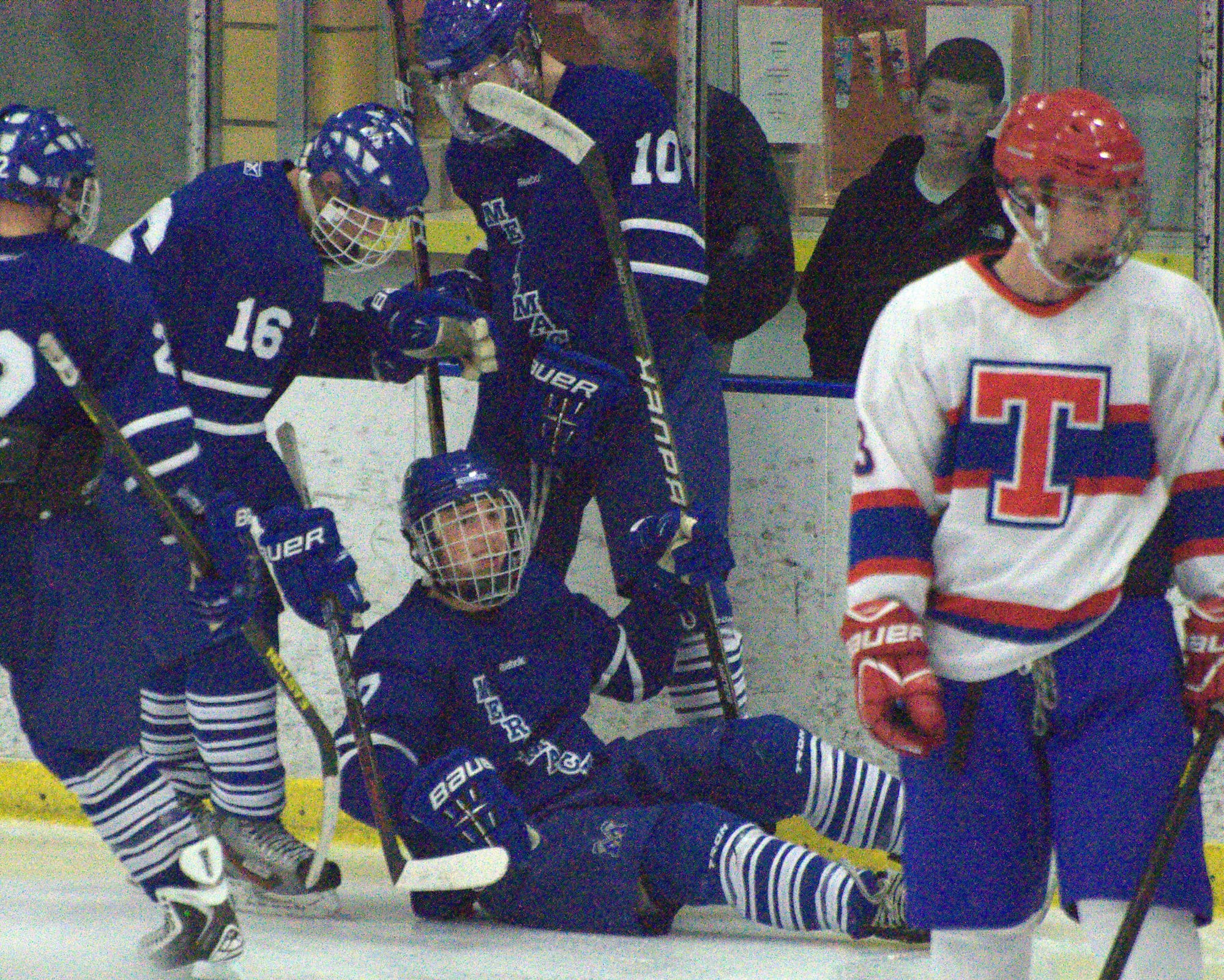 Merrimack's Jason Fortin, left, and Shane Foye help up Connor Powell after a goal Thursday against Trinity. For more photos, go to the Photo Album.
