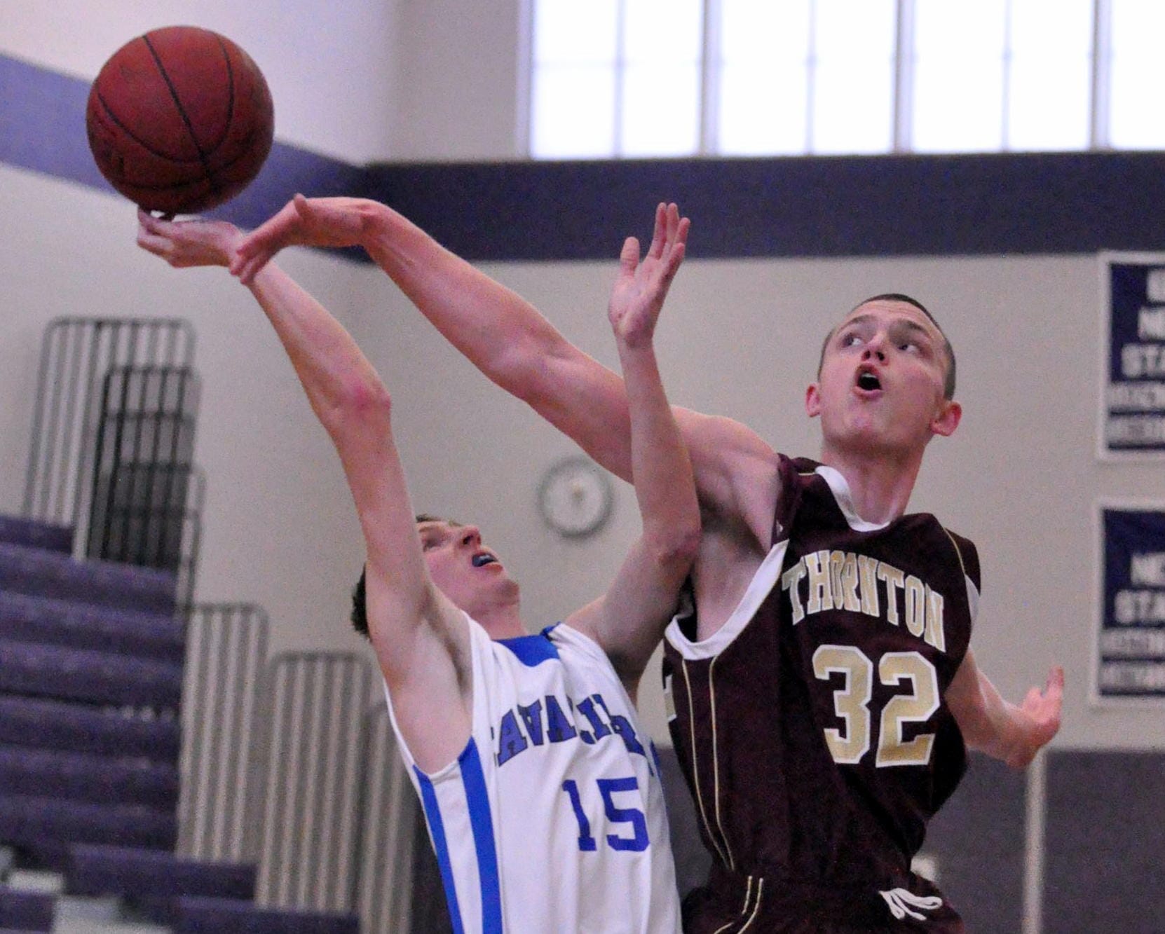 Thornton's Quinn Richardson-Newton blocks a shot by Hollis Brookline's Sam VanNoy during Saturday's game.