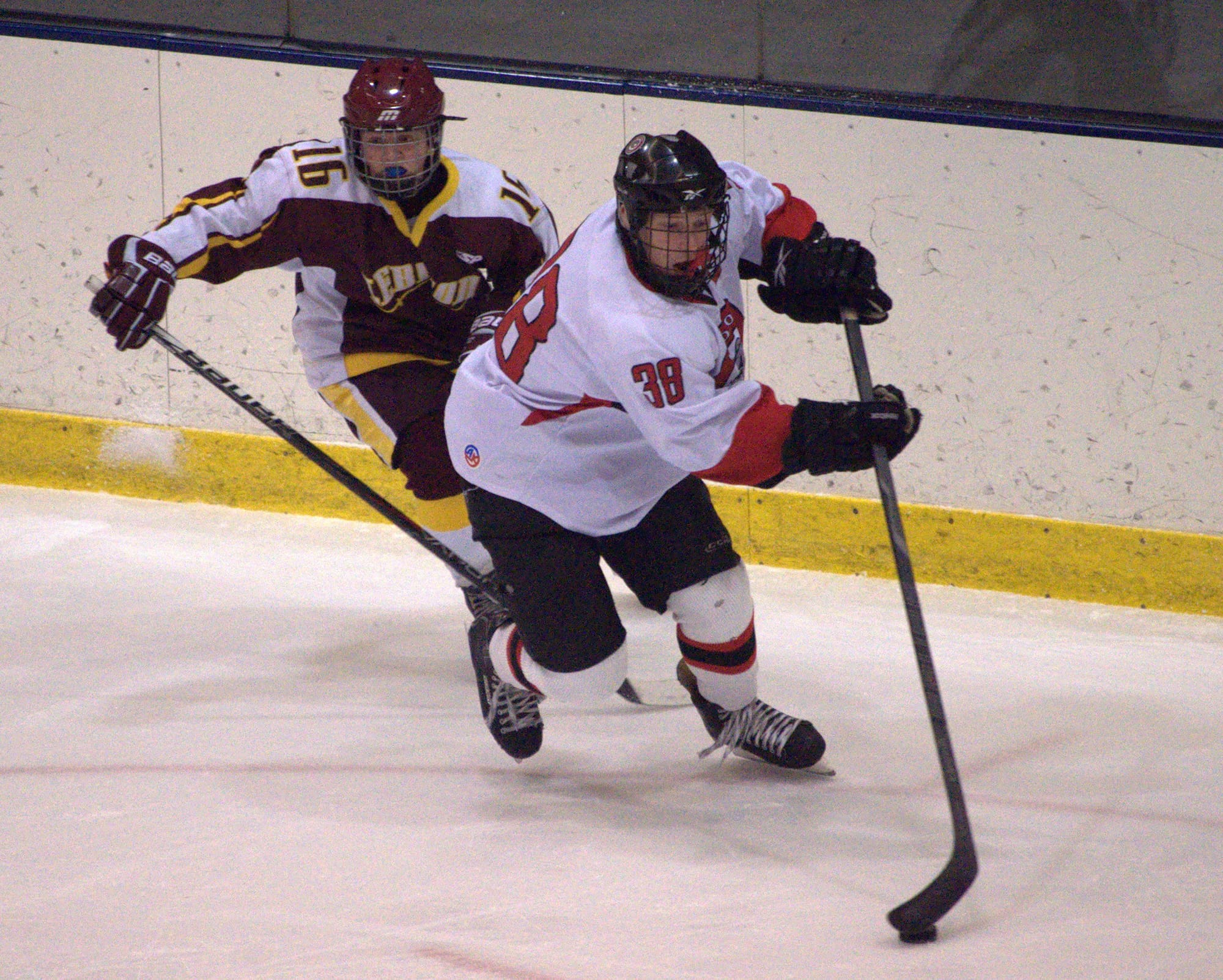 Bedford's Chris O'Hara tries to keep the puck away from Lebanon's Nathan Kriplin during Saturday's game. For more photos, go to the Photo Album.