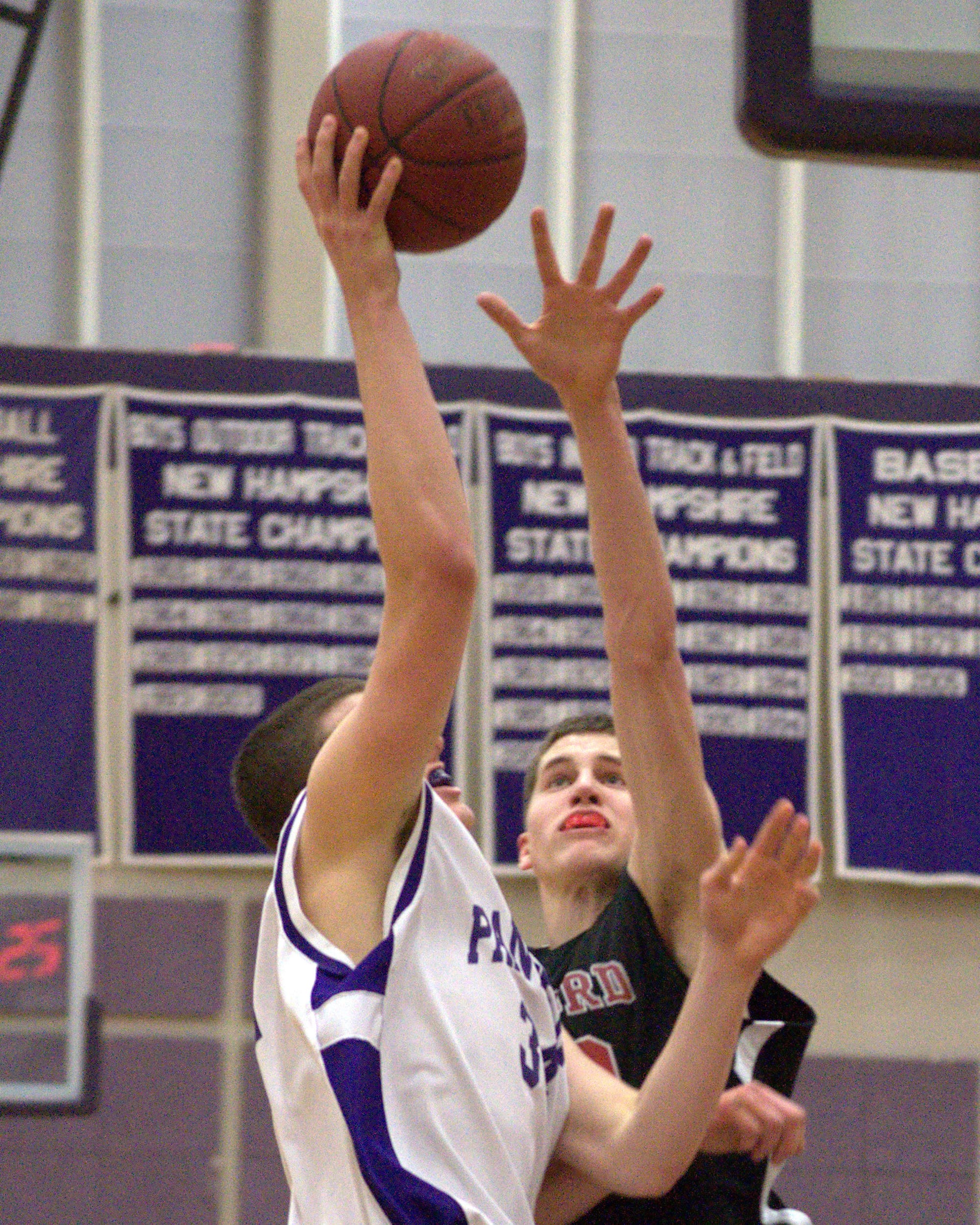 Bedford's Sam Thomas tries to block a shot by Nashua South's Jack Preston.