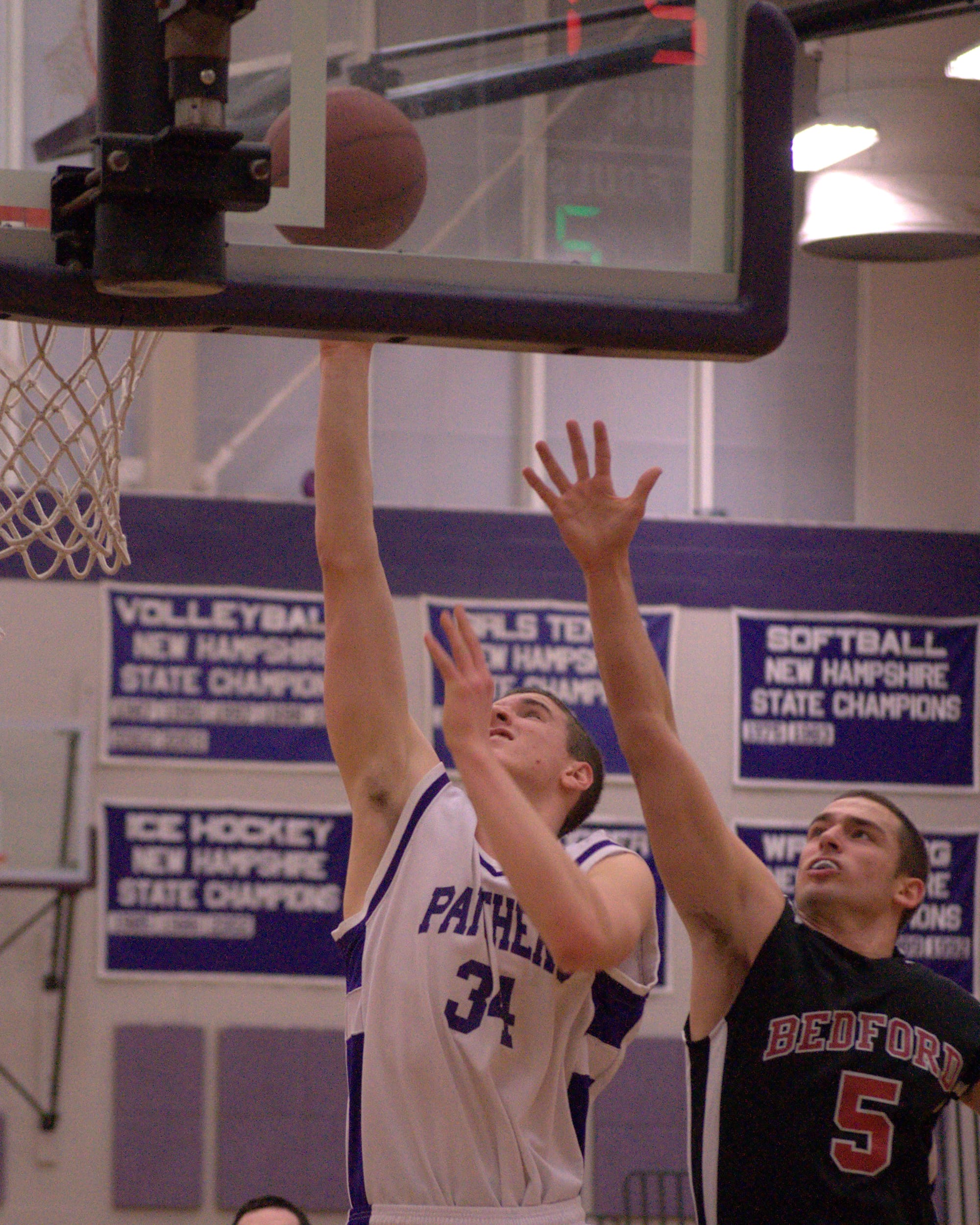 Bedford's James Caparell tries to defend as Nashua South's Jack Preston goes in for a layup Tuesday. For more photos, go to the Photo Album.