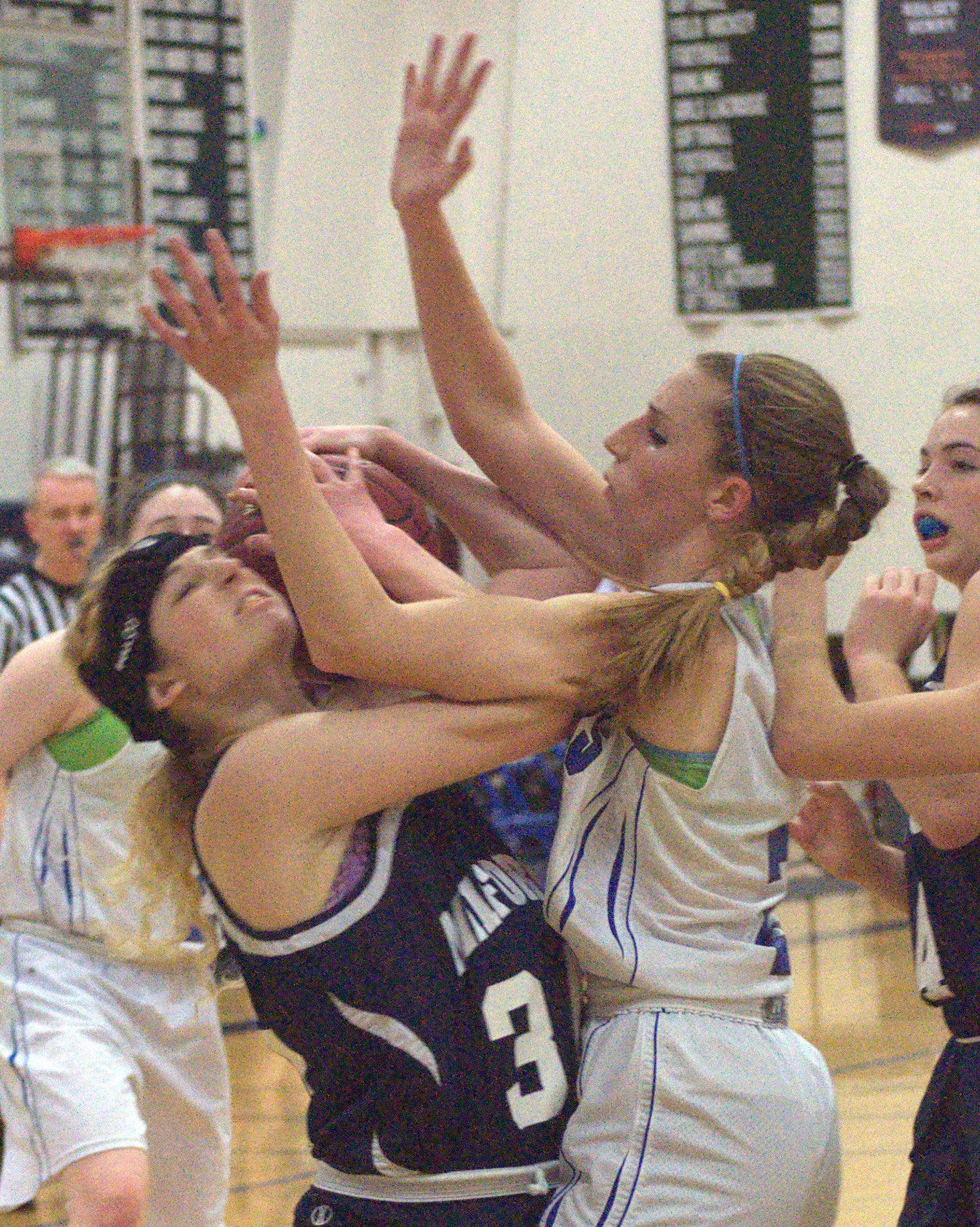Milford's Brianna Hoffman and Hollis Brookline's Erin Ackerly battle for a rebound during Friday's game. For more photos, go to the Photo Album.