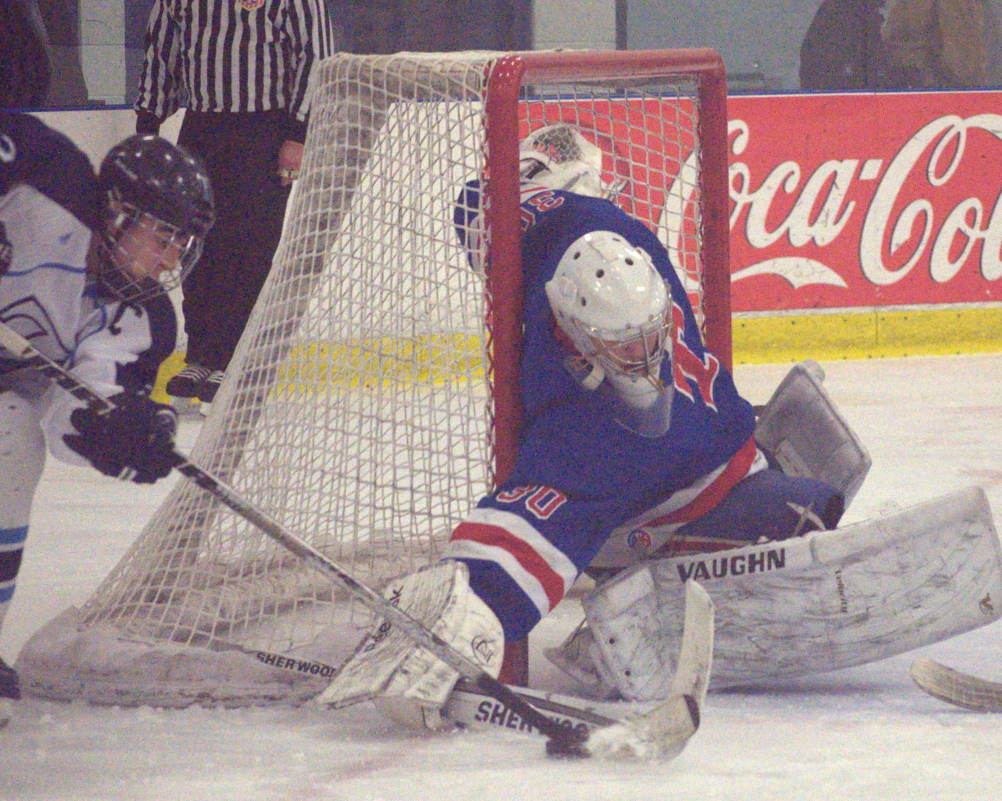 Trinity's Ryan Slatky tries to knock the puck away from Nashua North's Zach Taylor during Wednesday's game. For more photos, go to the Photo Album.