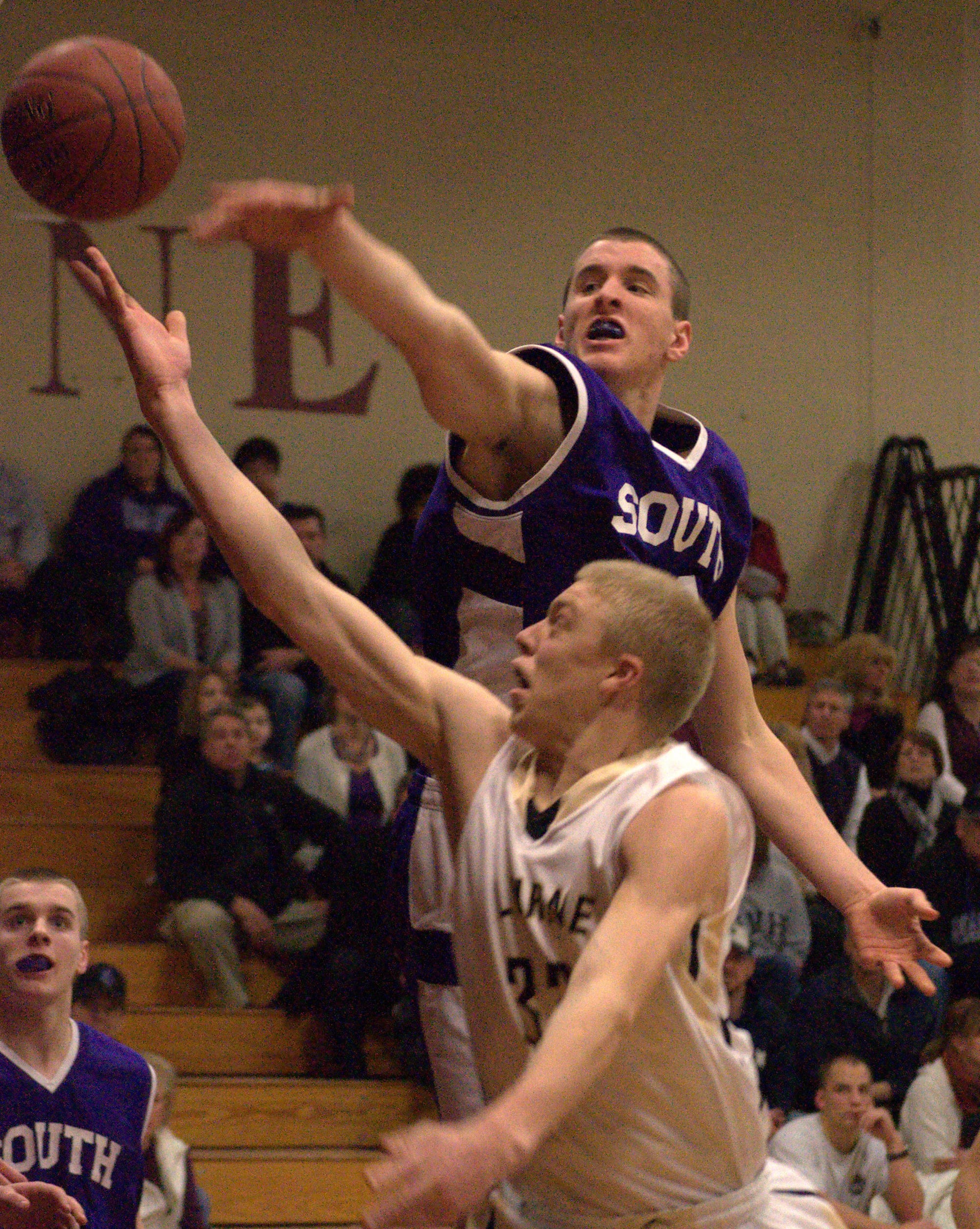 Nashua South's Jack Preston tries to block a shot by Alvirne's Tyler Livingston during Thursday's game. For more photos, go to the Photo Album.