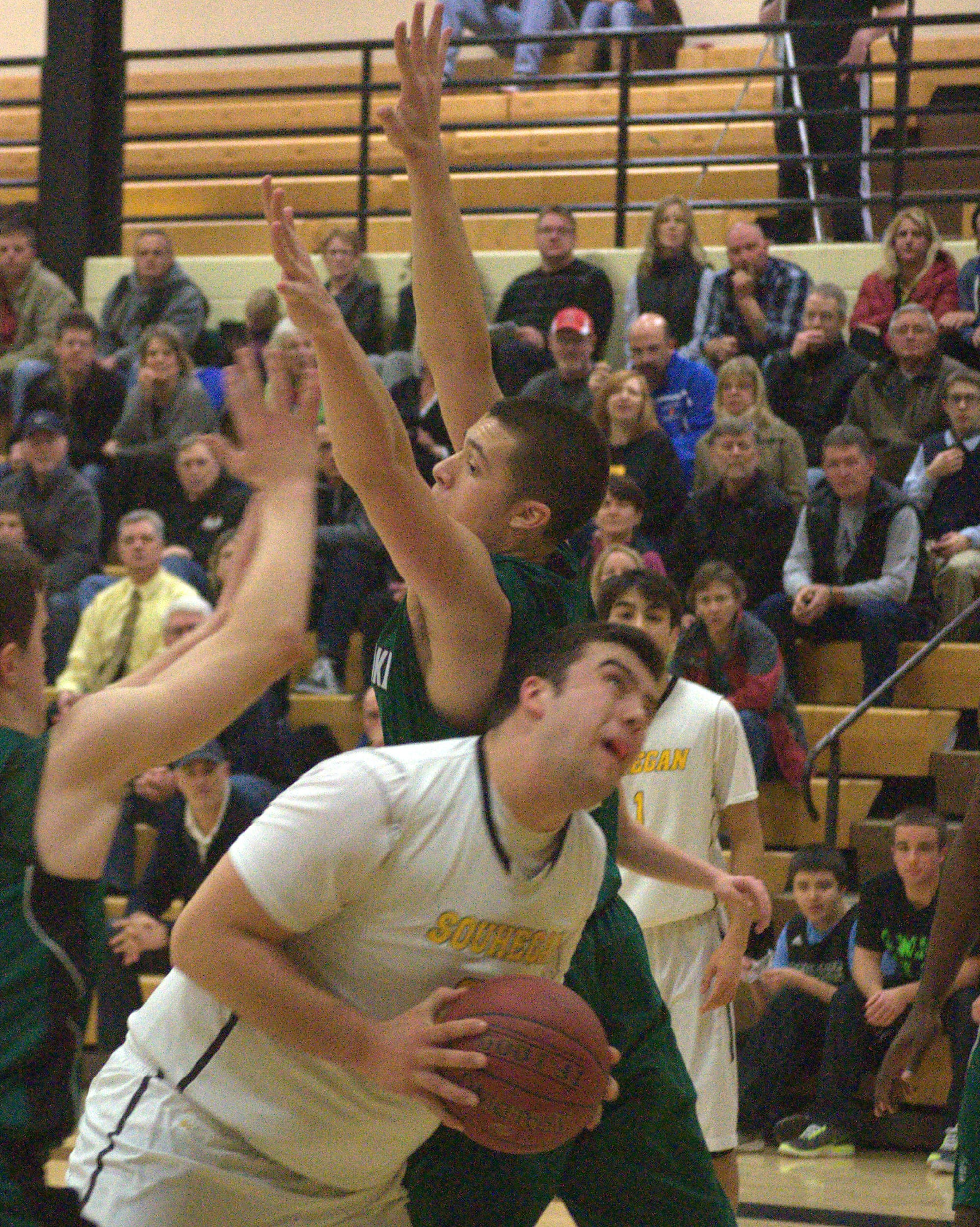 Souhegan's Jake Kennedy makes his way to the basket as Pembroke's Dominic Timbas defends during Tuesday's game.