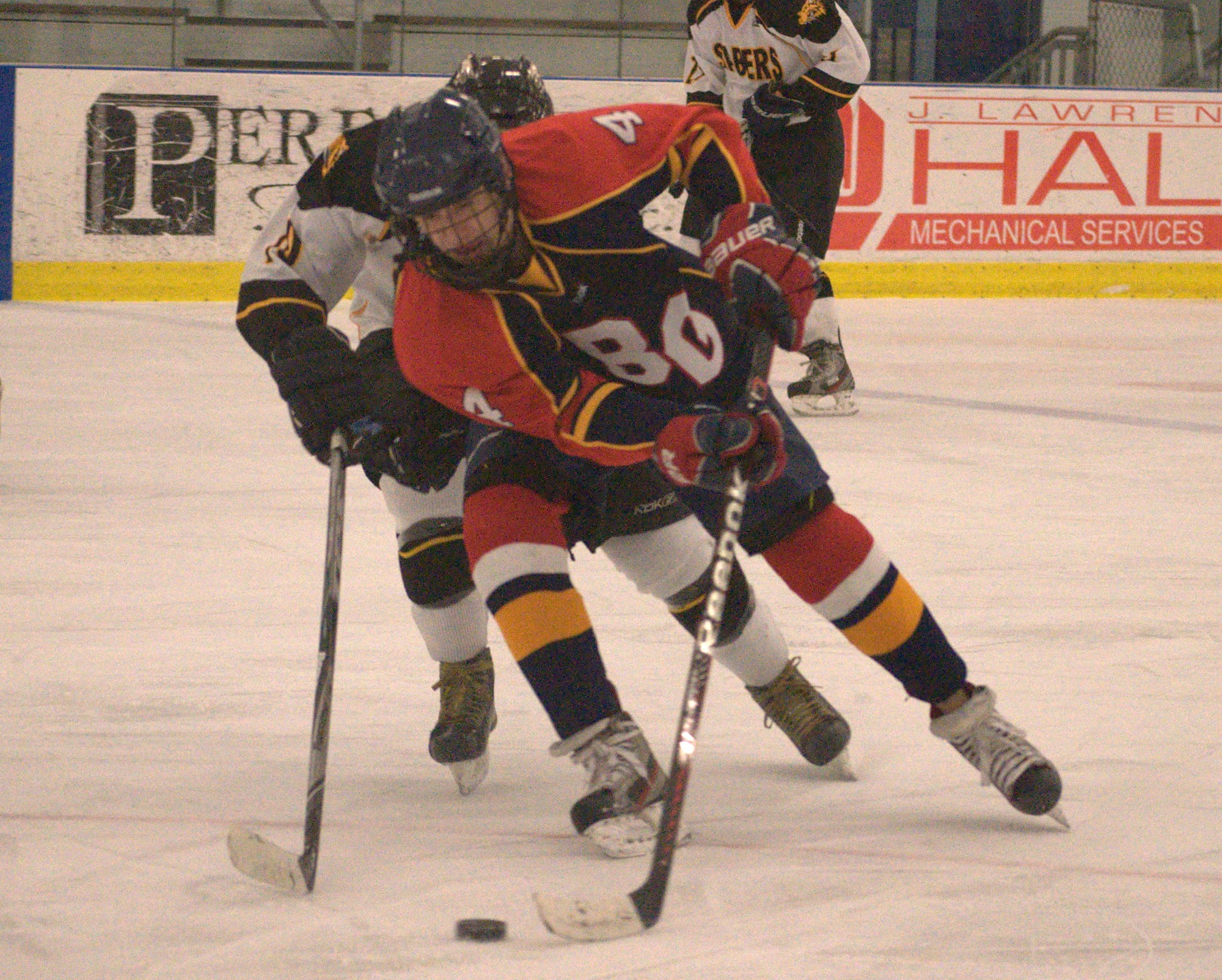 Belmont-Gilford's Andrew D'Amour tries to get by a Souhegan defenseman.