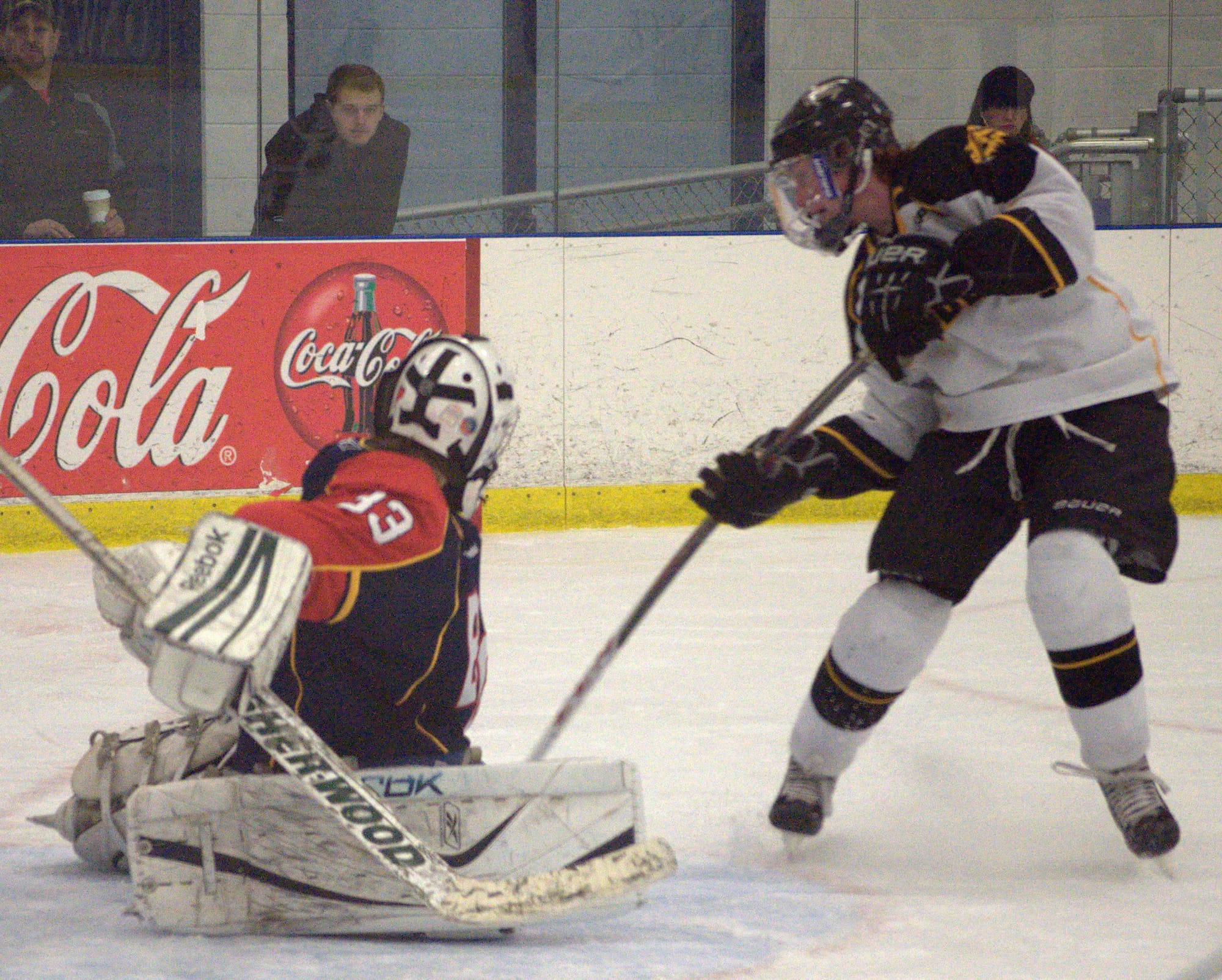 Souhegan's Joe Nutting puts the game-tying goal past Belmont-Gilford's Calvin Davis. For more photos, go to the Photo Album.