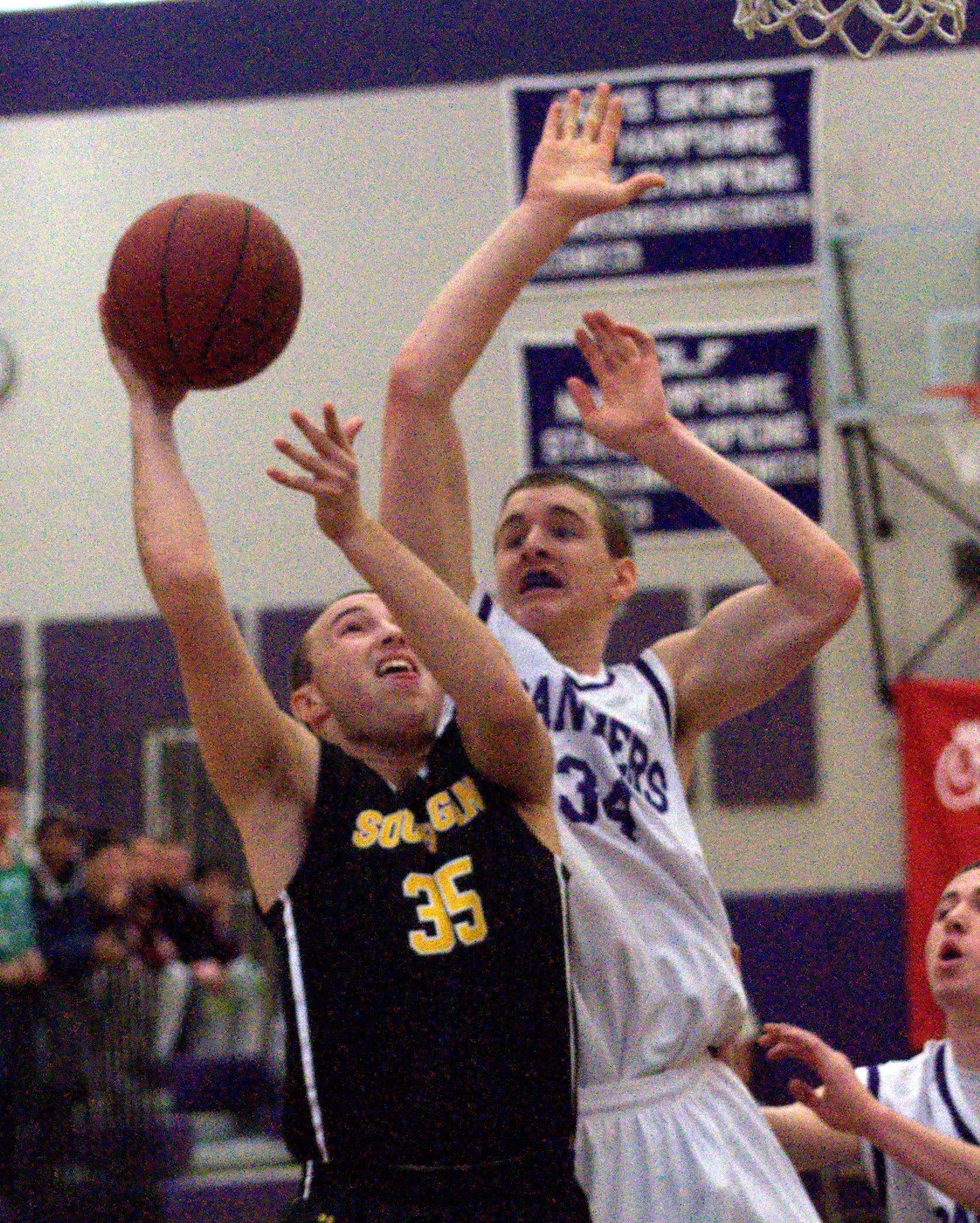 Souhegan's Josh Eichel tries to put up a shot against Nashua South's Jack Preston during Saturday's game.