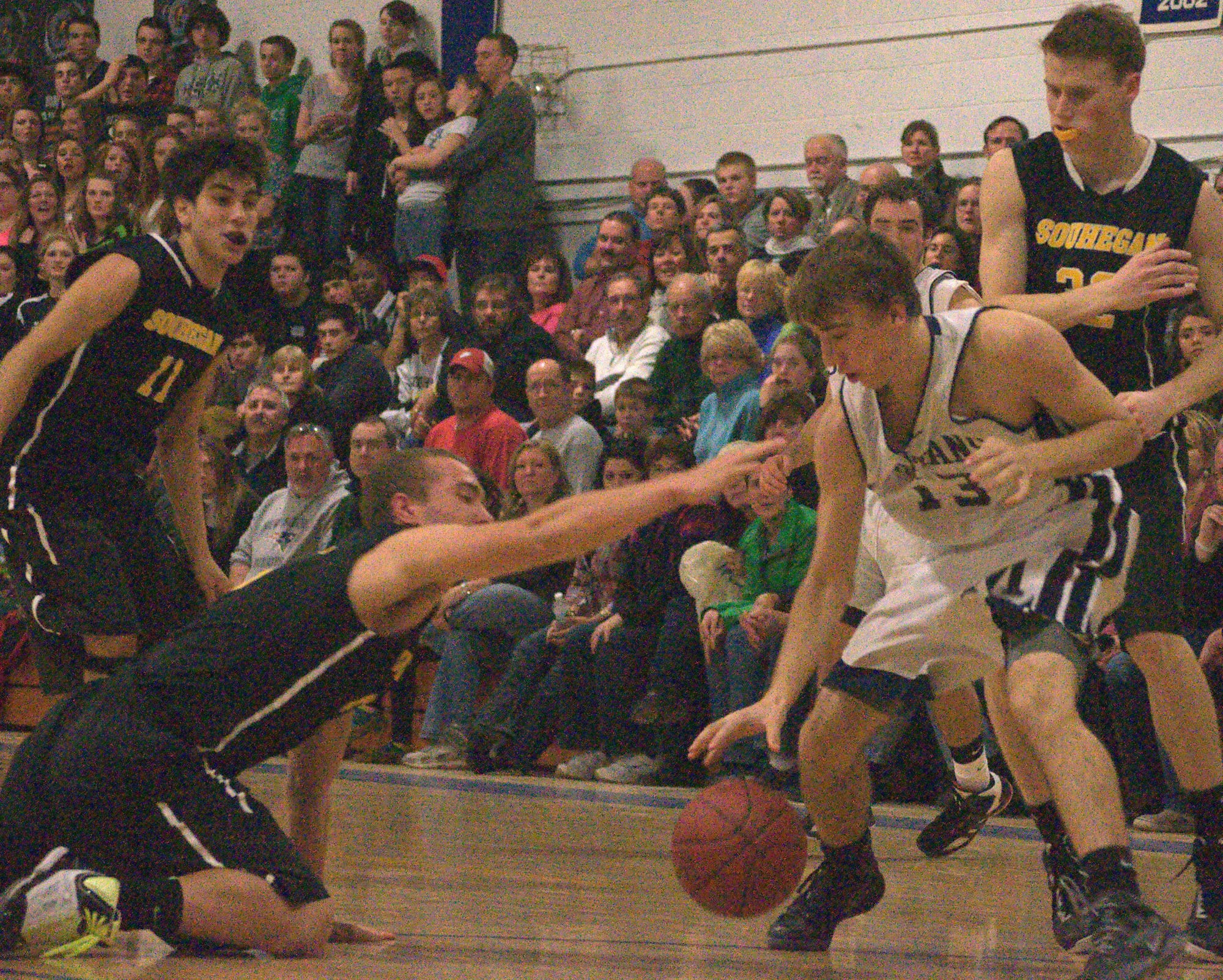 Souhegan's Trey Darrow tries to knock the ball away from Milford's Ross Briggs during Friday's game.
