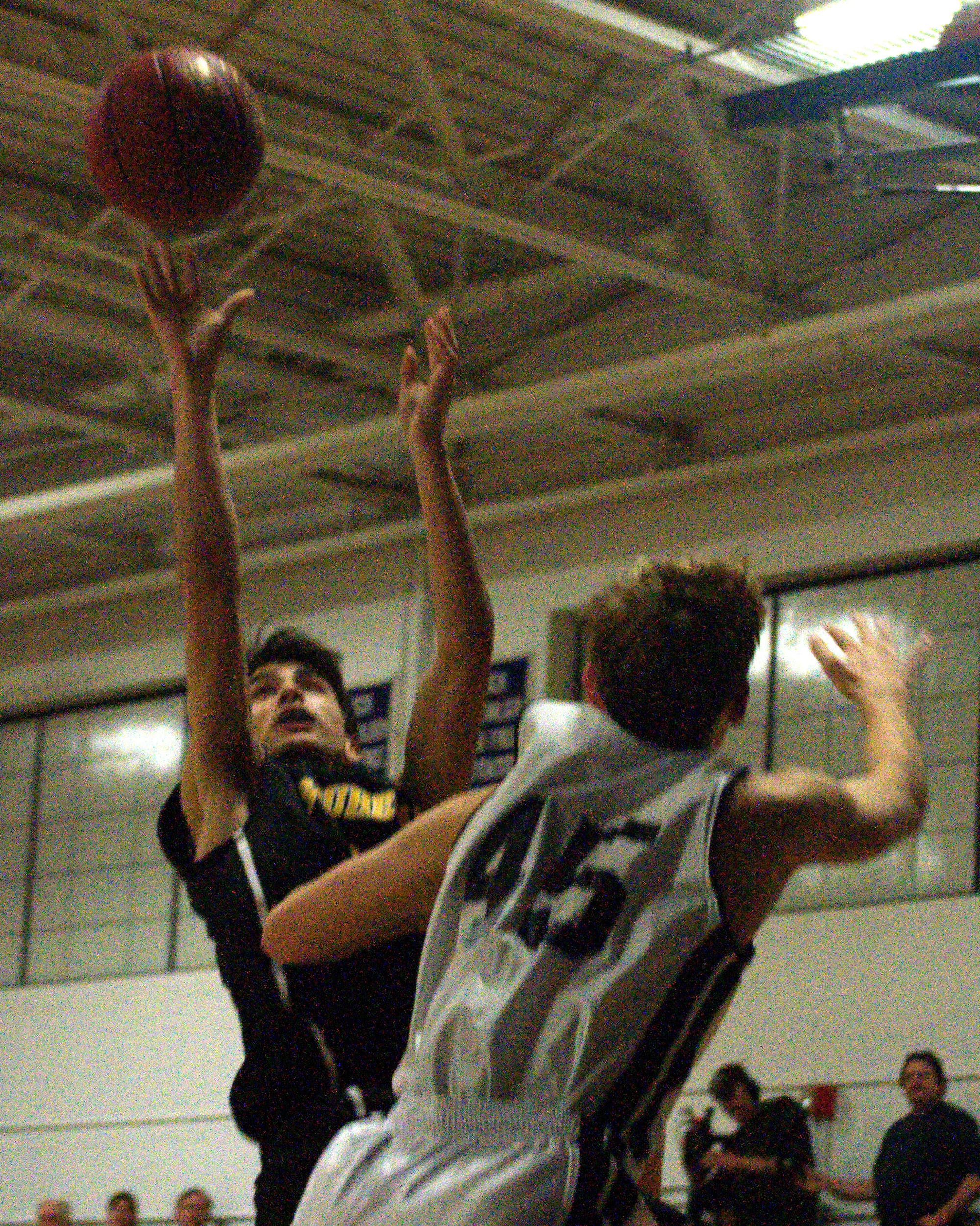 Souhegan's Brandon Len puts up a shot over Milford's Jarad Asselin.