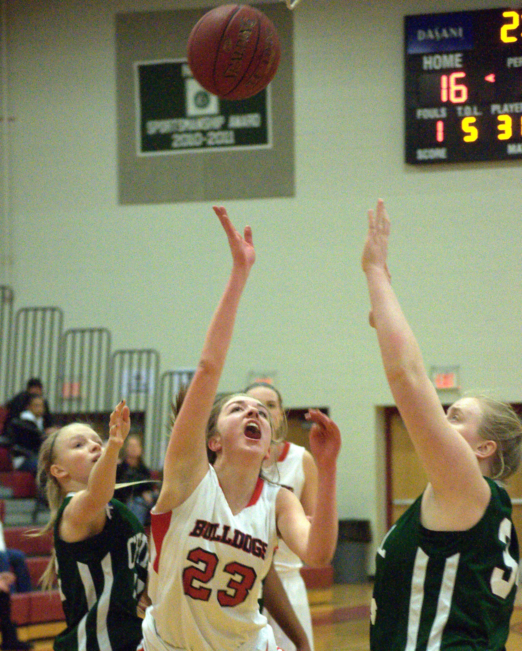 Bedford's Ali Glennon puts up a shot as Manchester Central's Devin Lacroix, left, and Angelina Marazzi defend. For more photos, go to the Photo Album.
